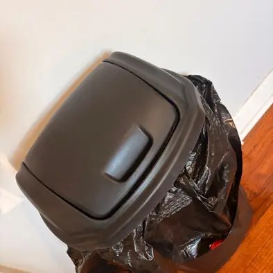 The same trash can after cleaning, wiped down with a fresh bag