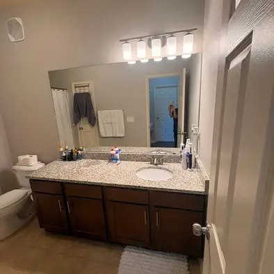 A sparkling bathroom vanity and mirror after a clean